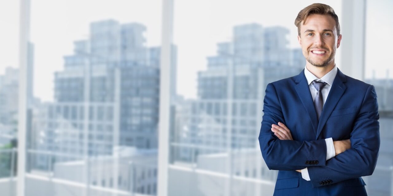 Businessman standing with arms crossed The First-Time Executive Playbook
