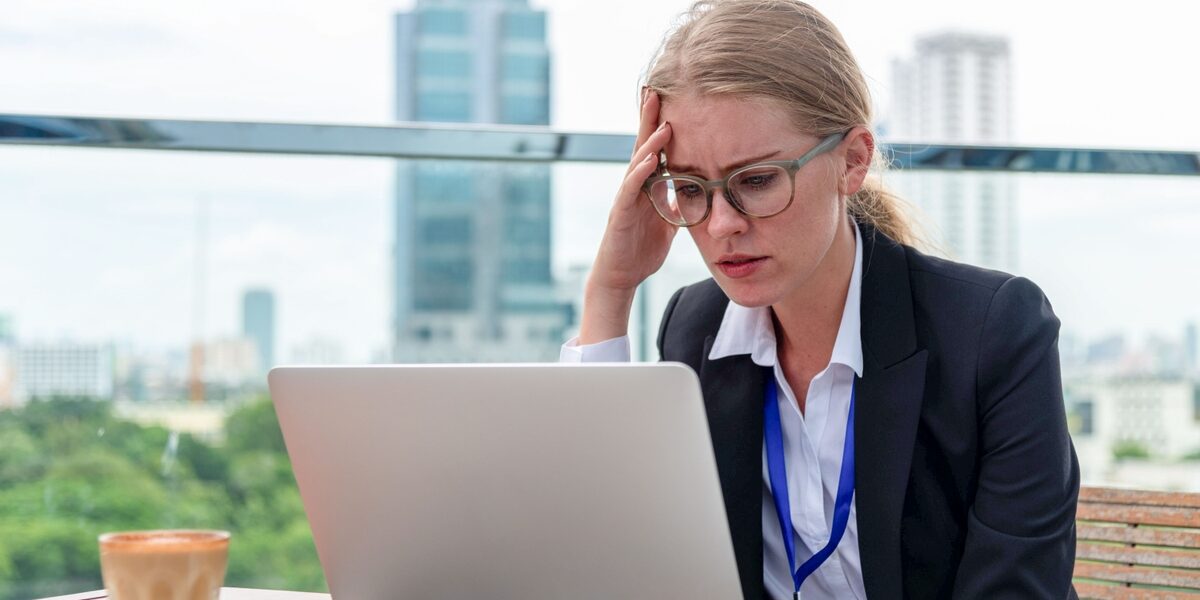 Stressed businesswoman working outdoors photo How to Lead When You’re No Longer the Expert
